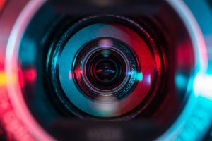 camera lens blue red neon lights reflection glass abstract photo surveillance observation